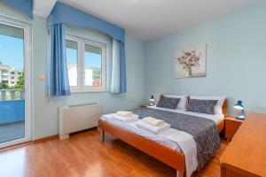a bedroom with a bed and a large window at Villa Ani in Trogir +44 photos
