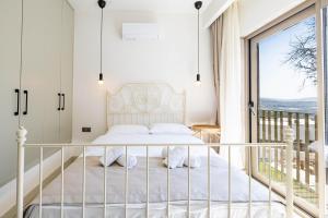 a bedroom with a bed and a balcony at Villa Luna Bodrum, Özel Isıtmalı Havuzlu in Ortakent +54 photos