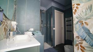 a bathroom with a sink and a toilet and a shower at Didinas room in Potenza