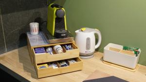a table with a hair dryer next to a coffee maker at Didinas room in Potenza +9 photos