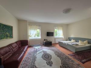a living room with a couch and a table at PP Pension Potsdam in Potsdam
