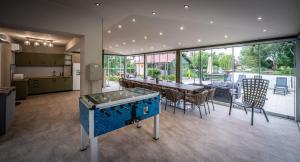 a kitchen and dining room with a ping pong table at Diófa Vendégház in Békésszentandrás