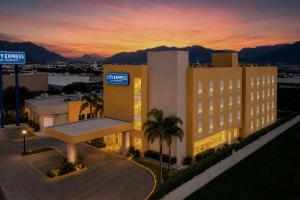a building with a sign in front of it at City Express by Marriott Monterrey Santa Catarina in Monterrey