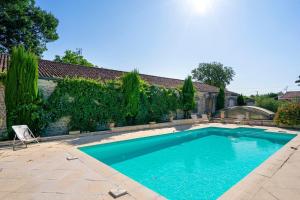 a swimming pool in the backyard of a house at Domaine De La Perthuiserie in Saint-Porchaire