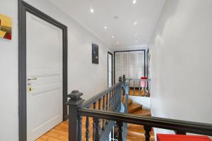 a staircase in a house with a white door at Domaine De La Perthuiserie in Saint-Porchaire