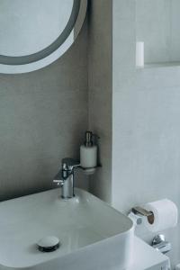 a bathroom with a white sink and a mirror at Клубний дім D2 in Chornomorsk +20 photos