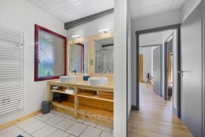 a bathroom with two sinks and a large mirror at Le Cocon Vendéen Chambres D'hôtes in Saint-André-Goule-dʼOie +61 photos