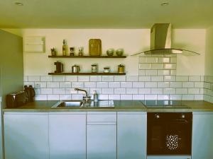 a kitchen with a sink and a stove at An Garraí Mór in Omagh