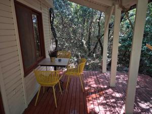 a porch with a table and chairs on it at Ronit and Mario in Abirim