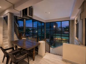 a dining room with a table and some chairs at Home Stay Inn 5 min from Sardar Vallabhbhai Patel International Airport Ahmedabad in Ahmedabad