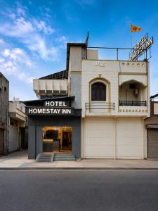 a hotel hominy inn on the corner of a street at Home Stay Inn 5 min from Sardar Vallabhbhai Patel International Airport Ahmedabad in Ahmedabad