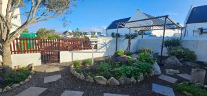 a garden with flowers and plants in a yard at Harts Water in Jacobs Bay