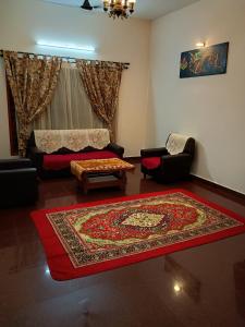 a living room with a couch and a rug at Aanchal Nest in Mangalore