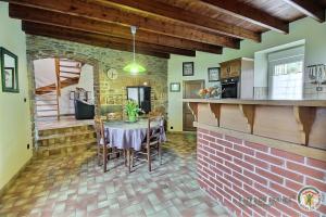 a kitchen and dining room with a table with chairs at Les hauts de kergiquel in Paimpol