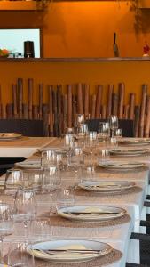 a long table with wine glasses and plates on it at Residence Toscano in Palmi