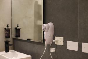 a hair dryer on a wall in a bathroom at Origen Patagonia Hotel in Puerto San Julián