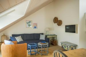 a living room with a blue couch and a table at Lustrup Farmhouse in Ribe