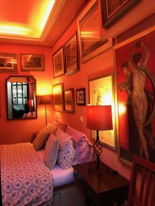 a bedroom with a bed and a painting on the wall at Gallery Basement in Villa Vravrona in Markopoulo