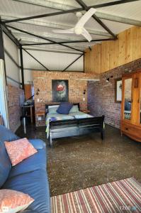 a bedroom with a bed in a brick wall at Kairos Vista in Sedgefield
