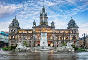 a large building with a fountain in front of it at Holiday Inn Express Glasgow City Theatreland by IHG in Glasgow