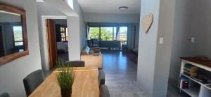 a dining room and living room with a table and chairs at Cormorants' View Self Catering accommodation in Sedgefield