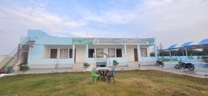 a building with a table and chairs in front of it at The Pool place and Restaurant in Bagar Meo