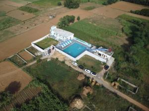 an aerial view of a house with a swimming pool at The Pool place and Restaurant in Bagar Meo