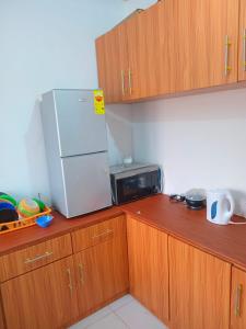 a kitchen with a white refrigerator and a microwave at Master Home in Baatsona