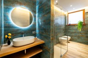 a bathroom with a sink and a mirror at Casa Sgubin in Cormòns +37 photos