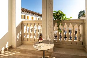 a couple of bottles of wine sitting on a balcony at Casa Sgubin in Cormòns