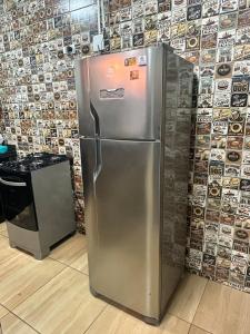 a stainless steel refrigerator in front of a wall at Área de Lazer DAY USE - Chácara do Danilo in Maringá