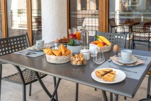 a table with bread and other food on it at Casa Sgubin in Cormòns