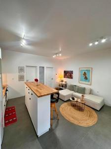 a kitchen and living room with a table and a couch at Asterias in Skiros