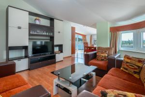 a living room with a couch and a tv at Villa Ani in Trogir