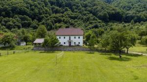 an aerial view of a white house in a field at Bujtina Mitaj in Vermosh