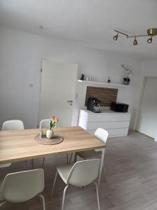 a dining room with a wooden table and chairs at Ferienwohnung Nele in Heimbach +6 photos