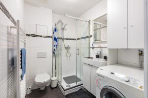 a bathroom with a shower and a toilet and a sink at Ferienwohnung Casa Marco 1 in Grenzach-Wyhlen +11 photos