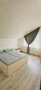 a bedroom with a large bed in front of a window at Dreams House in Yengidzha +36 photos