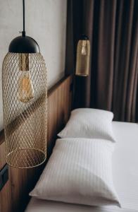 a bedroom with two white pillows and a bird cage at Клубний дім D2 in Chornomorsk