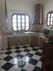 a kitchen with a black and white checkered floor at Amsa aqua villa in Tétouan
