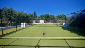a tennis court with a net on top of it at Coudour Boutique Hotel in Pesádha