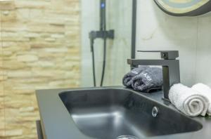 a sink in a bathroom with a towel at Rafaela Sea Gem in Loutraki