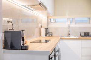 a kitchen with a coffee maker on a counter at Rafaela Sea Gem in Loutraki +8 photos