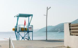 a lifeguard station on a beach with the water at Rafaela Sea Gem in Loutraki
