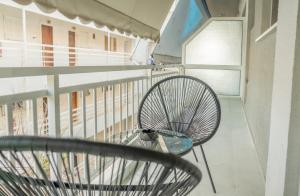 a metal chair sitting on a balcony at Rafaela Sea Gem in Loutraki