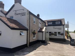 a couple of buildings sitting next to each other at The Carpenters Tavern in Dundry