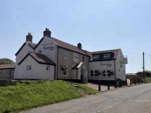 a building on the side of a street at The Carpenters Tavern in Dundry