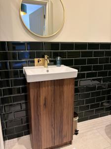 a bathroom with a sink and a mirror at The Carpenters Tavern in Dundry