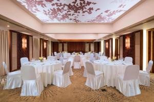 a banquet room with white tables and chairs and a ceiling at Sheraton Samui Resort in Chaweng Noi Beach +96 photos