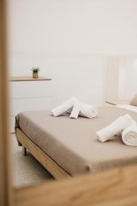 a bed in a room with towels on it at Le Volte in Lizzano +16 photos